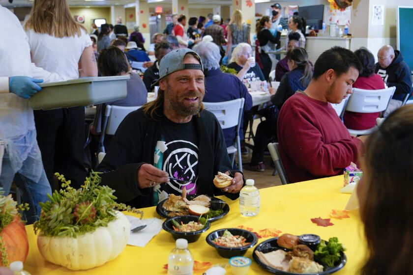 San Diego, CA - November 19: At the San Diego Rescue Mission’s annual Thanksgiving dinner on Saturday, Nov. 19, 2022 in San Diego, CA., Ryan Carlson was among the hundreds who enjoyed Thanksgiving meal in the dining room. Carlson says she’s been homeless for the past couple of years. (Nelvin C. Cepeda / The San Diego Union-Tribune)