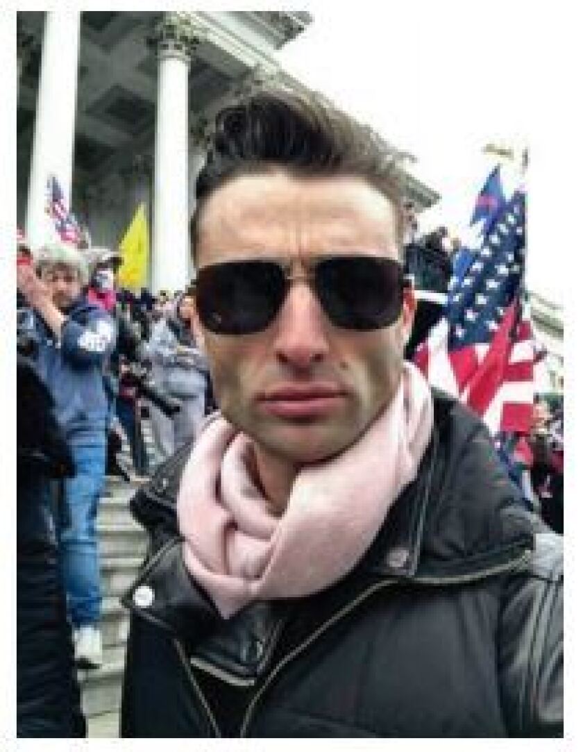 A man in sunglasses and a scarf 
