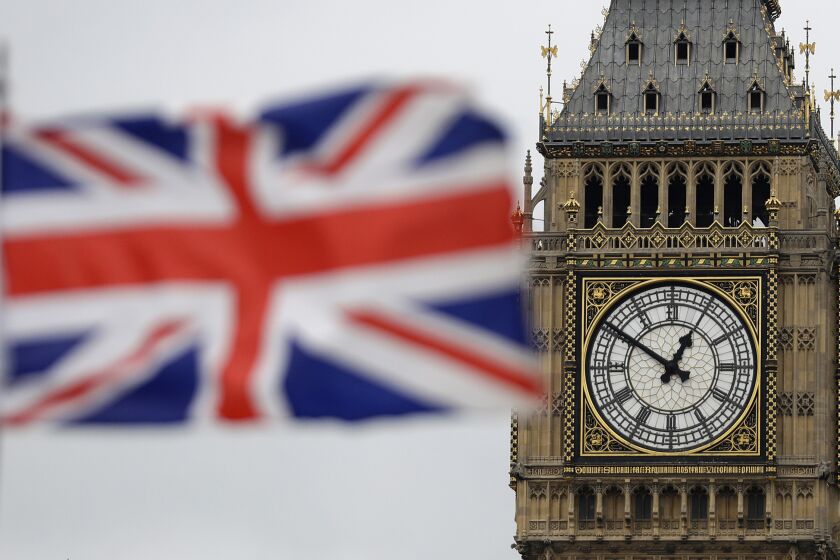 FILE - In this Wednesday, March 29, 2017 file photo British Union flag waves in front of the Elizabeth Tower at Houses of Parliament containing the bell know as "Big Ben" in central London. (AP Photo/Matt Dunham, File)
