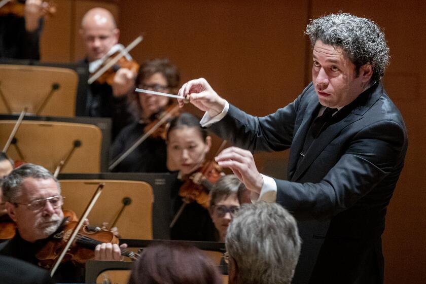 LOS ANGELES, CALIF. -- SATURDAY, NOVEMBER 2, 2019: Gustavo Dudamel conducts the LA Phil during performance of Andrew Norman’s centennial commission, “Sustain,” at the Walt Disney Concert Hall in Los Angeles, Calif., on Nov. 2, 2019. (Brian van der Brug / Los Angeles Times)