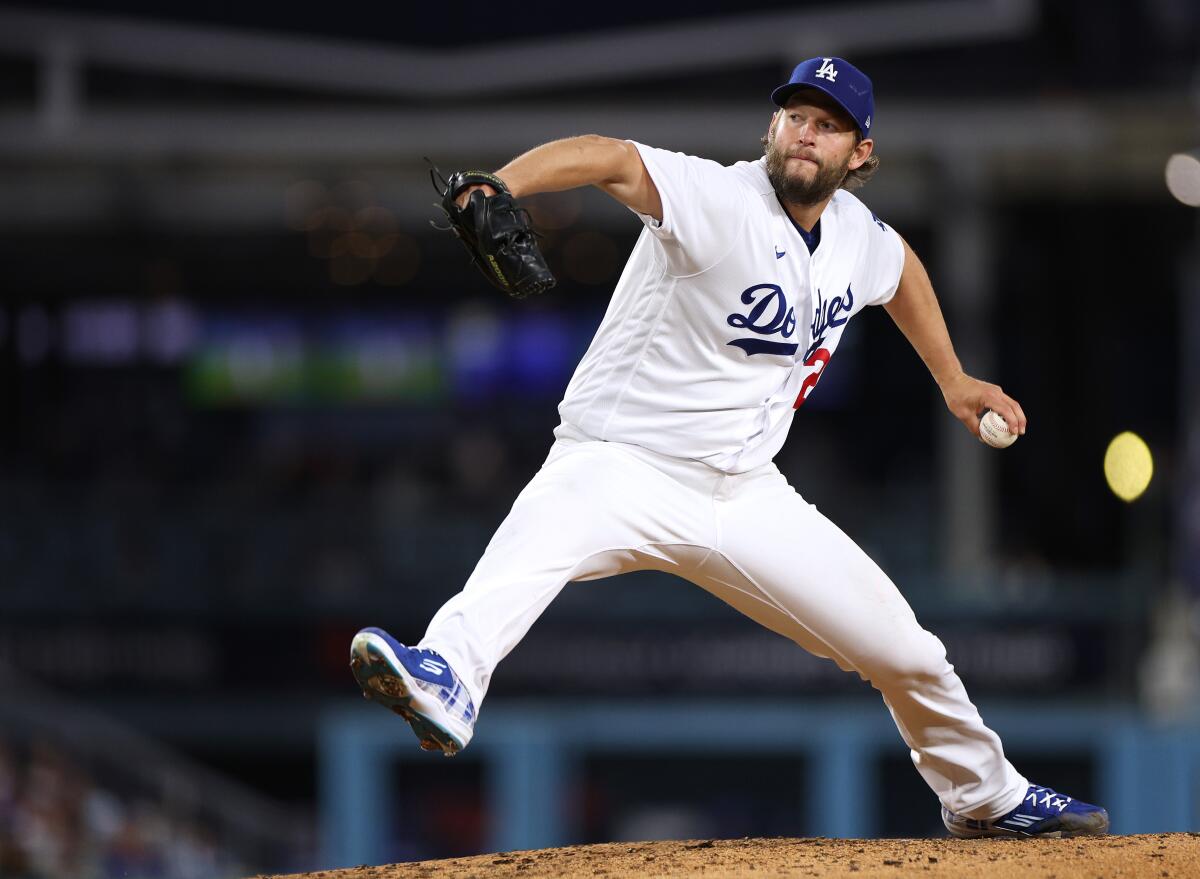 Clayton Kershaw has one foot in the air and is holding onto the ball before a pitch.
