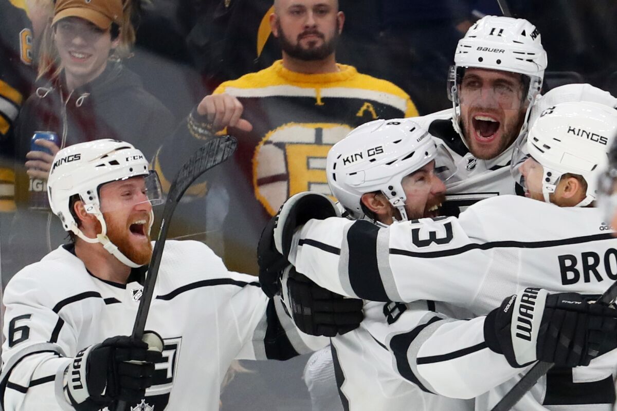 Kings captain Anze Kopitar, top right, celebrates with teammates (from left) Joakim Ryan, Drew Doughty and Dustin Brown.