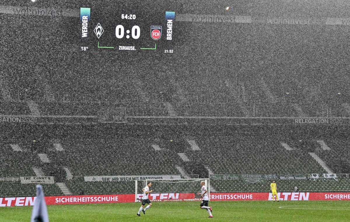 The board shows the result in heavy rain during the German Bundesliga relegation first leg soccer match between Werder Bremen and 1. FC Heidenheim in Bremen, Germany, Thursday, July 2, 2020. Because of the coronavirus outbreak all soccer matches of the German Bundesliga take place without spectators. (AP Photo/Martin Meissner, Pool)