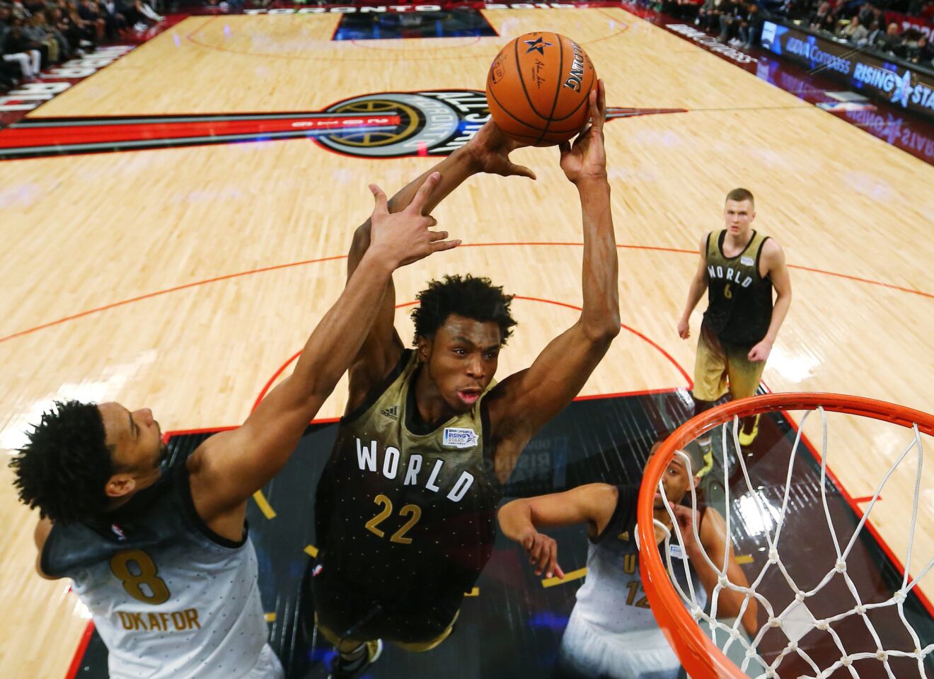 76ers forward Jahlil Okafor of the U.S. team tries to block a shot by Timberwolves forward Andrew Wigging of the World team during the Rising Stars Challenge.