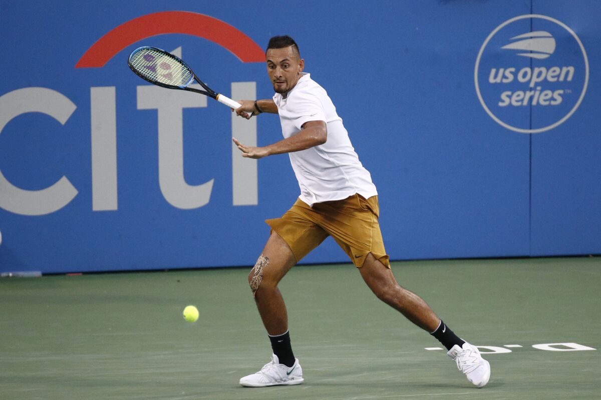 FILE - In this Saturday, Aug. 3, 2019, file photo, Nick Kyrgios, of Australia, returns the ball to Stefanos Tsitsipas, of Greece, during a semifinal at the Citi Open tennis tournament in Washington. The tournament that was supposed to mark the official return of men’s professional tennis amid the coronavirus pandemic has been canceled. The Citi Open in Washington, scheduled to start with Aug. 13 qualifying, was called off Tuesday, July 21, 2020, because of what tournament manager Mark Ein said are “too many unresolved external issues, including various international travel restrictions as well as troubling health and safety trends.”(AP Photo/Patrick Semansky, File)