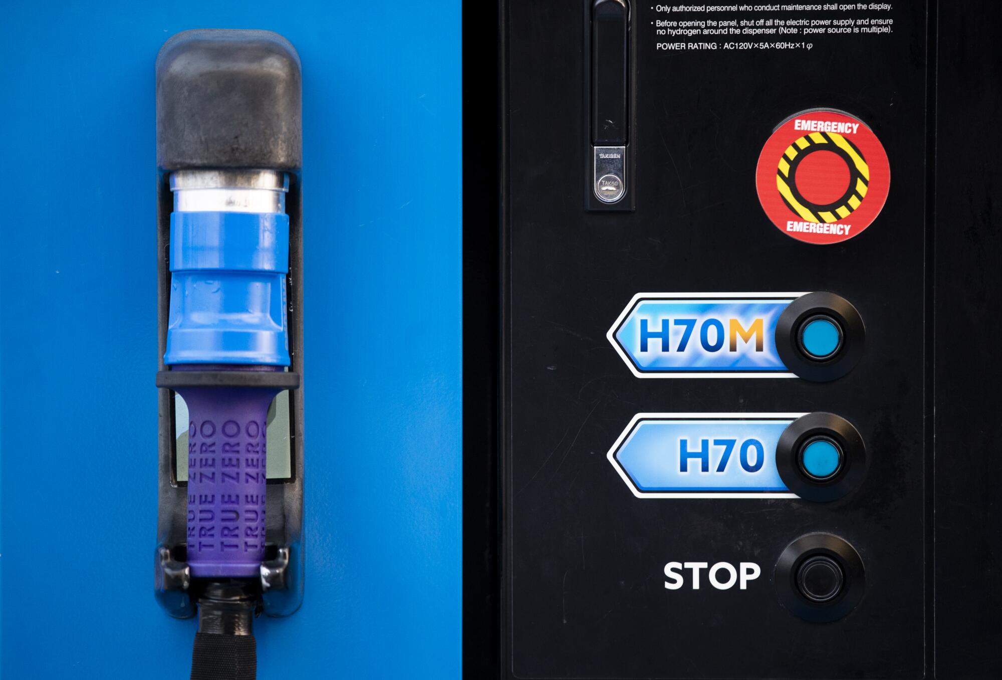 Part of a hydrogen dispenser, the pump handle is on the left, the push buttons on the right.