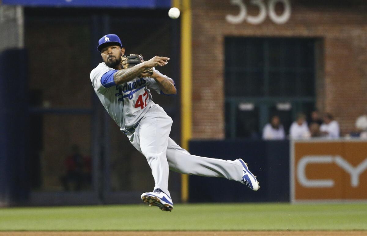 Dodgers second baseman Howie Kendrick makes an off-balance throw to first base to put out Padres outfielder Matt Kemp in the fourth inning Saturday night in San Diego.