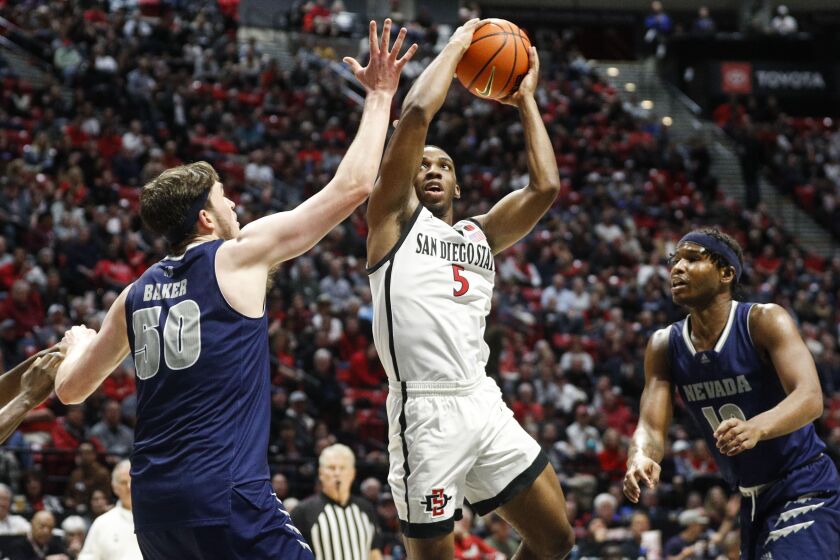 San Diego, CA - January 10: San Diego State guard Lamont Butler (5) goes up for a shot against Nevada center Will Baker (50) at Viejas Arena on Tuesday, Jan. 10, 2023 in San Diego, CA. (Meg McLaughlin / The San Diego Union-Tribune)