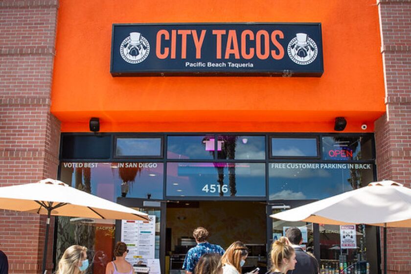 Customers line up for takeout outside City Tacos in Pacific Beach.