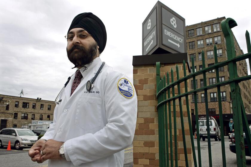 Dr. Kamal S. Kalsi stands Thursday, June 4, 2009, near Saint Joseph's hospital in Paterson, N.J., where he works. Kalsi, a Sikh, is also a captain in the U.S. Army and is reporting for duty in July. He had been under the impression that his beard and turban are allowed, but recently found out that is not the case. The Army has sent a letter saying they're going to review the policy. (AP Photo/Mel Evans)