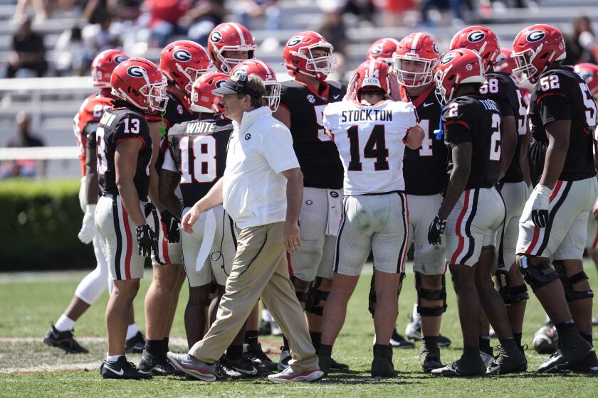 Georgia head coach Kirby Smart walks past the Black Team huddle during the second half of an NCAA college spring football game Saturday, April 13, 2024, in Athens, Ga. (AP Photo/John Bazemore)