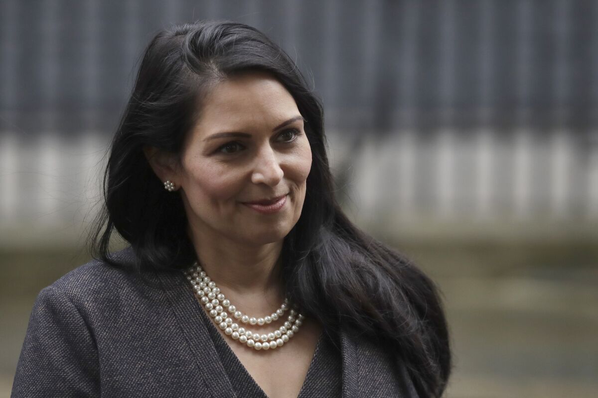 FILE - In this file dated Thursday, Feb. 13, 2020, British Home Secretary lawmaker Priti Patel, leaves 10 Downing Street in London. Relations between British government and ice cream maker Ben & Jerry’s chilled Tuesday, Aug. 11, 2020 in a spat about the treatment of migrants. The Vermont-based dessert brand directed a tweet Monday at Britain’s interior minister, Home Secretary Priti Patel, who has vowed to stop asylum seekers crossing the English Channel from France to England in small boats. Hundreds have made the dangerous crossing in the past weeks of calm summer weather. (AP Photo/Matt Dunham, File)