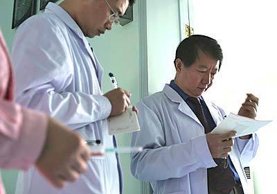 Dr. Huang Hongyun, standing right, is pictured with colleagues at The Neurological Disorder Center in Beijing West Hill Hospital, China. Neural patients having Amyostrophic Lacteral Sclerosis (ALS) or spinal cord injury come from all over the world to seek Dr. Huang for his surgical process, an injection of olfactory ensheathing glia cells prepared from aborted fetuses.