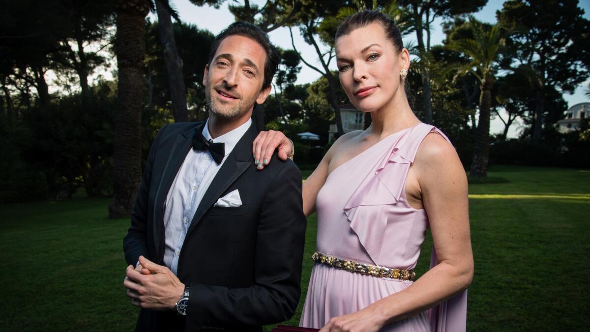 Adrien Brody and Milla Jovovich attend the amfAR gala.