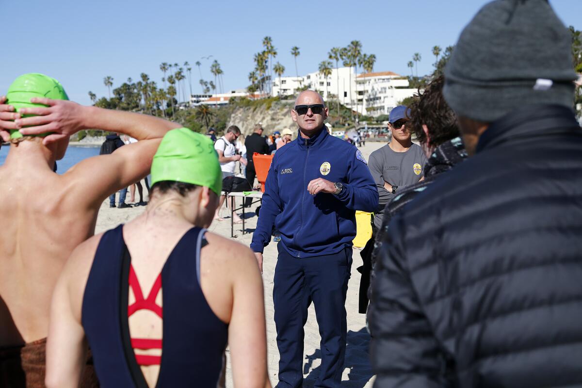 Laguna Beach Marine Safety Captain Kai Bond, center, speaks to participants during lifeguard tryouts at Main Beach.