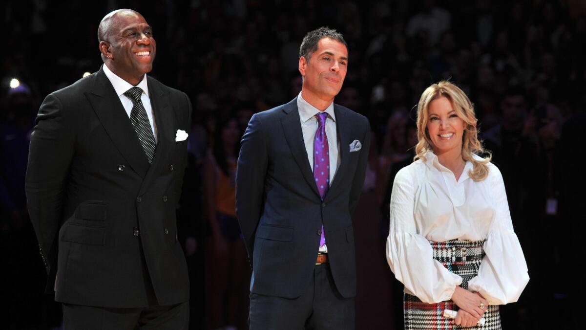 From left: Magic Johnson, Rob Pelinka and Jeanie Buss attend Kobe Bryant's jersey retirement ceremony in December 2017.