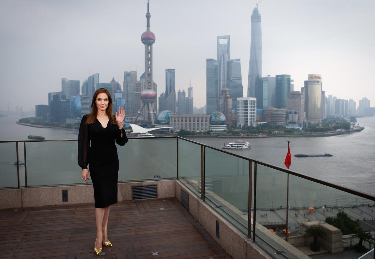Angelina Jolie poses on the terrace of a hotel in Shanghai during a press event promoting "Maleficent."