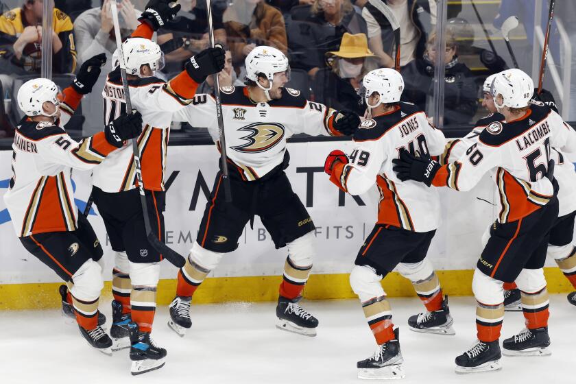 Anaheim Ducks' Mason McTavish (23) celebrates with teammates after his goal in overtime.