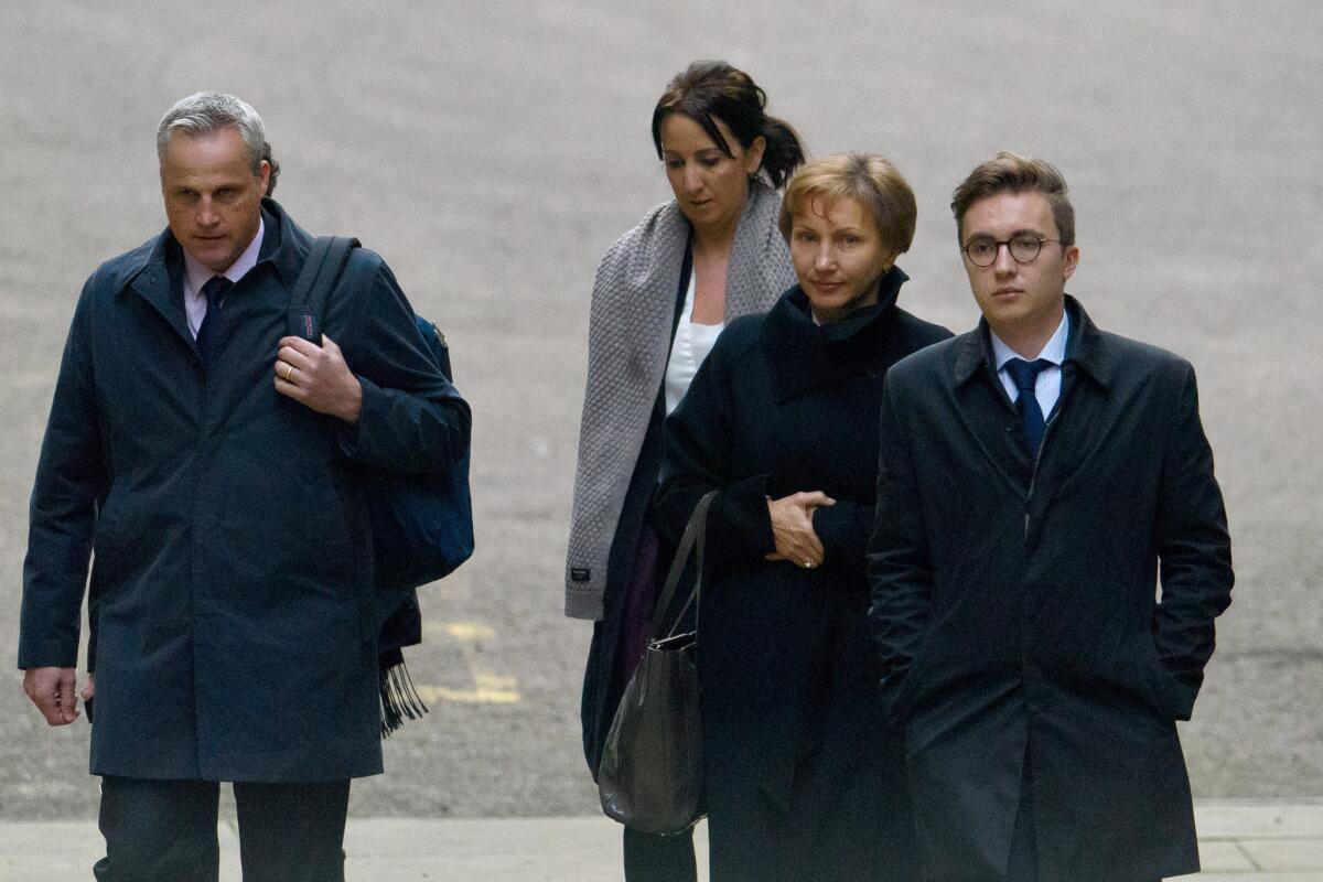 Alexander Litvinenko's widow, Marina, center right, and son Anatoly, right, arrive at the High Court in London to receive the results of the inquiry into the former agent's death.