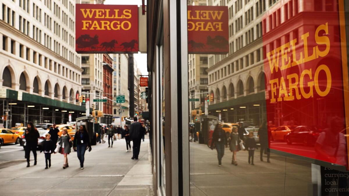 People walk by a Wells Fargo bank branch in New York City in October.