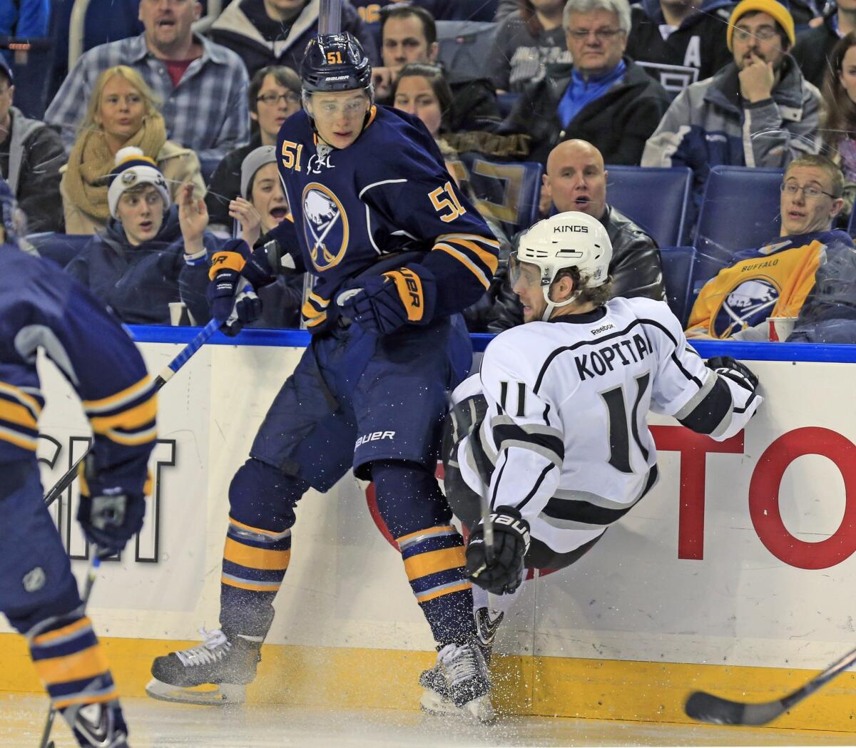 Anze Kopitar, right, is checked by Buffalo's Nikita Zadorov on Dec. 9.