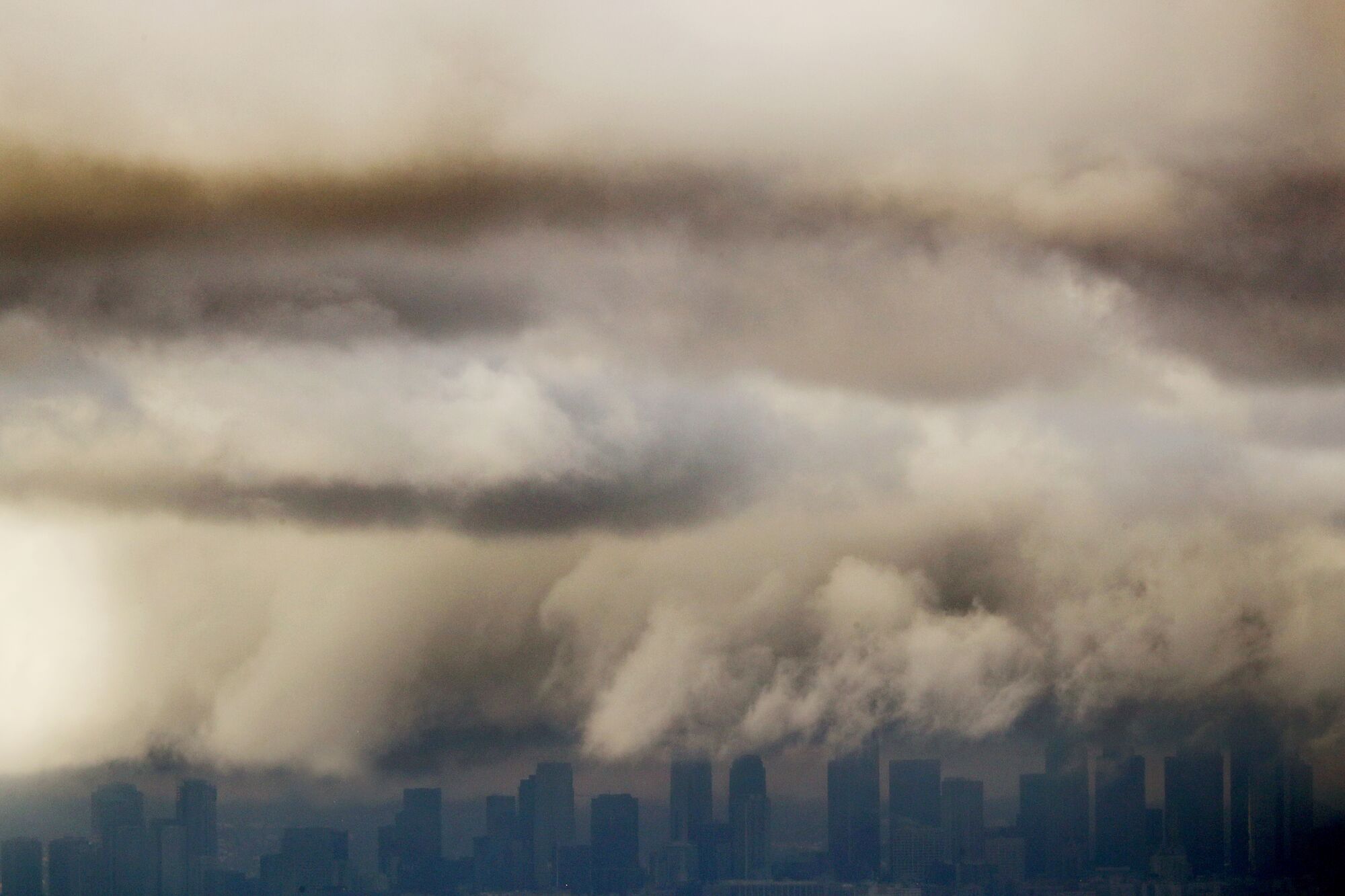 Storm clouds move over the skyline of downtown Los Angeles.