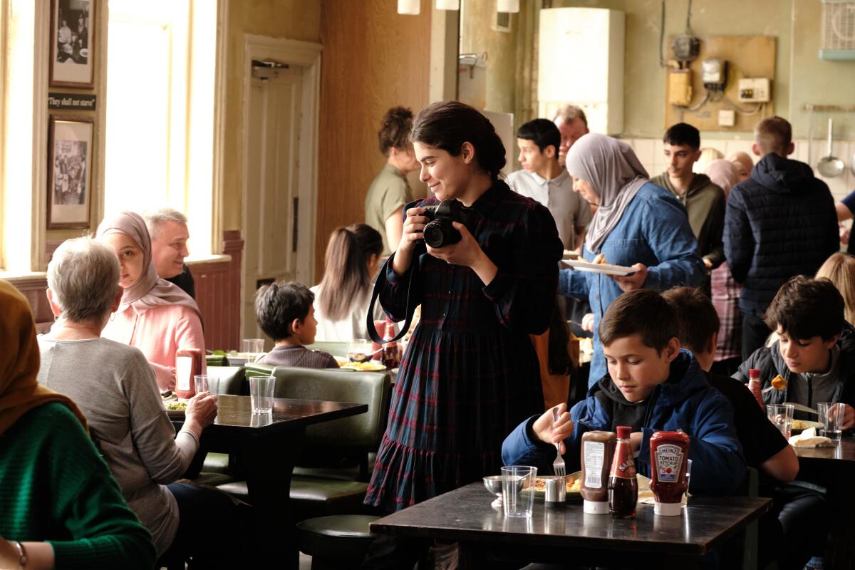 woman takes photos in a busy diner