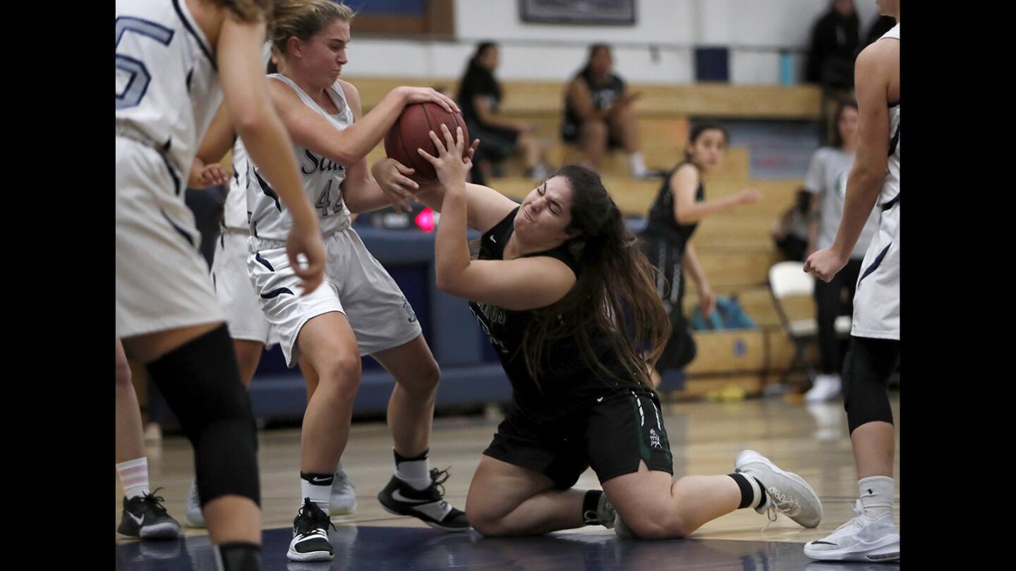 Costa Mesa High's McKayla Ortiz, right, battles Newport Harbor's Emma Fults, left, for a loose ball during the first half in a nonleague game on Tuesday, November 13.