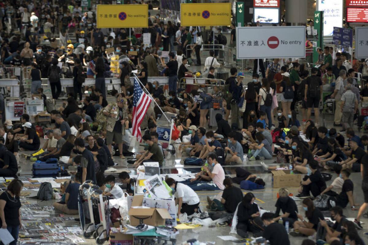 Protesters stage a sit-in Aug. 13 at the arrival hall of the Hong Kong International Airport.