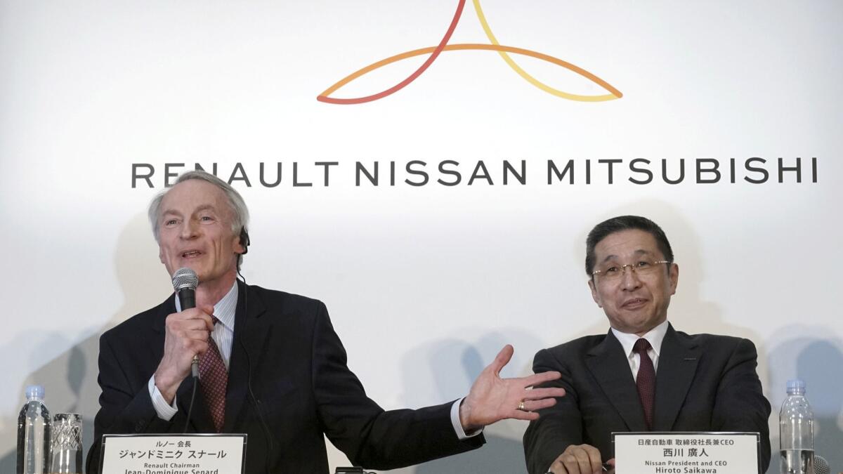 Renault Chairman Jean-Dominique Senard, left, speaks as Nissan CEO Hiroto Saikawa listens during a joint March 12 press conference at the Nissan headquarters in Yokohama, near Tokyo.