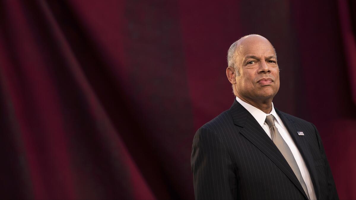 Jeh Johnson, secretary of the Department of Homeland Security, waits to swear in immigrants during a naturalization ceremony in New York.