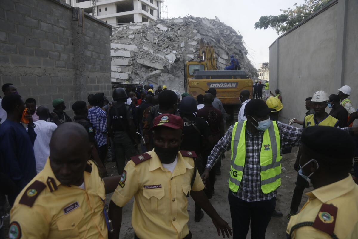 Rescue workers are seen at the site of a collapsed 21-story apartment building under construction in Lagos, Nigeria