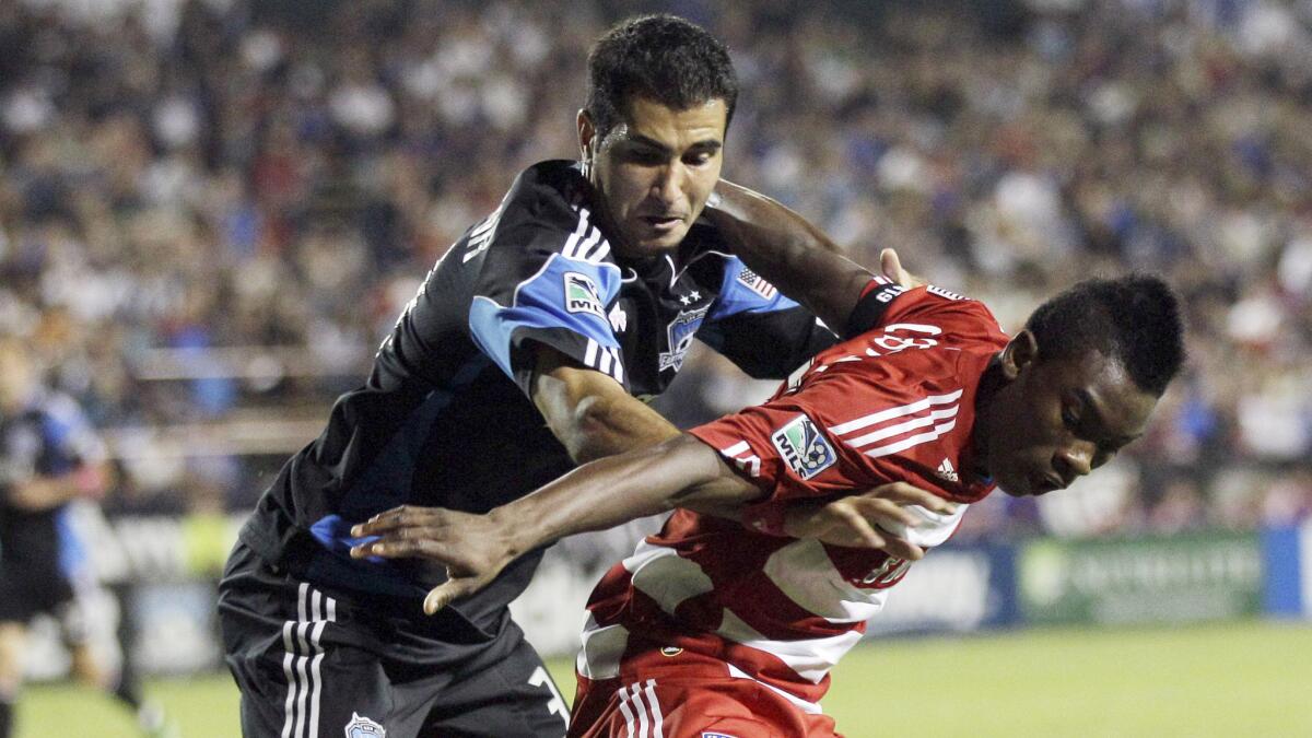 San Jose defender Steven Beitashour, left, battles for the ball with FC Dallas forward Fabian Castillo during a 2011 match. Beitashour hopes to be playing for Iran in next month's World Cup.