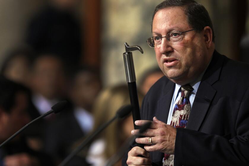 Los Angeles City Councilman Paul Koretz, holding a bullhook in 2013, as he argued for a ban on such implements to train or control elephants.