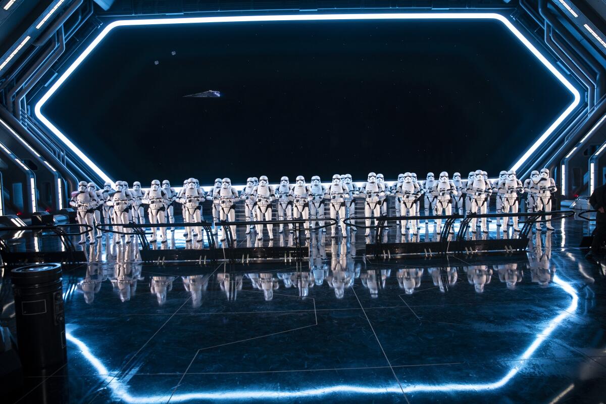 A crowd of Stormtroopers standing in front of a giant window looking out into space