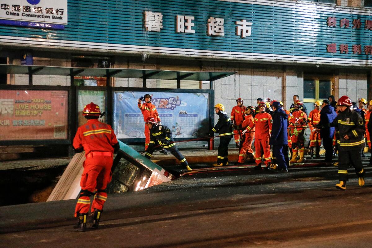 The bus tipped into the sinkhole at a stop just outside a health clinic in Xining. Security video showed it gradually settling in as people ran.