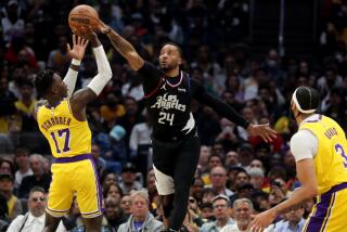 Clippers guard Norman Powell blocks a shot by Lakers guard Dennis Schroder 