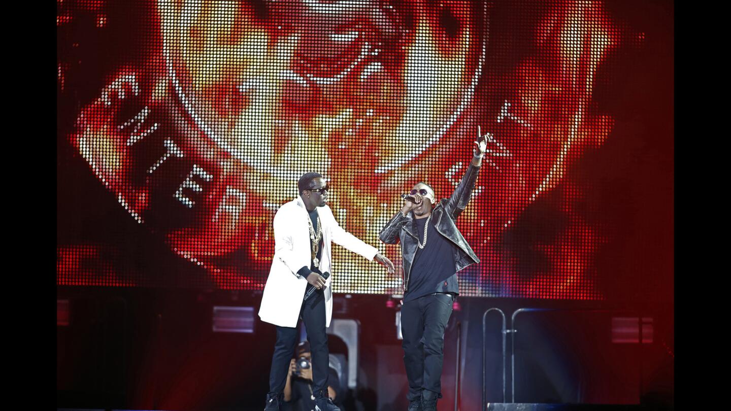Puff Daddy, left, and Mase perform during the Bad Boy Records 20th anniversary concert at the Forum.
