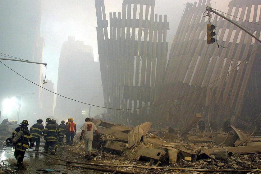 Firefighters make their way through the rubble of the World Trade Center 11 September 2001 in New York after two hijacked planes flew into the landmark skyscrapers. AFP PHOTO/Doug KANTER
