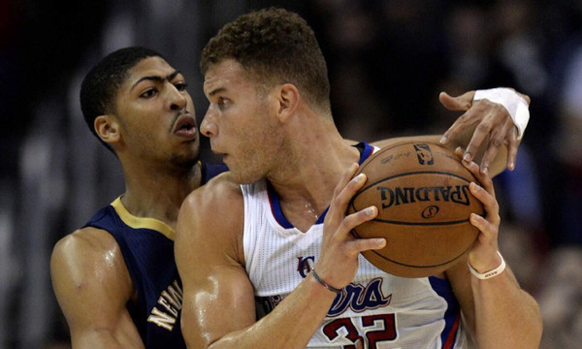 Clippers power forward Blake Griffin, right, tries to work past New Orleans Pelicans forward Anthony Davis during a Clippers' win on Dec. 18.