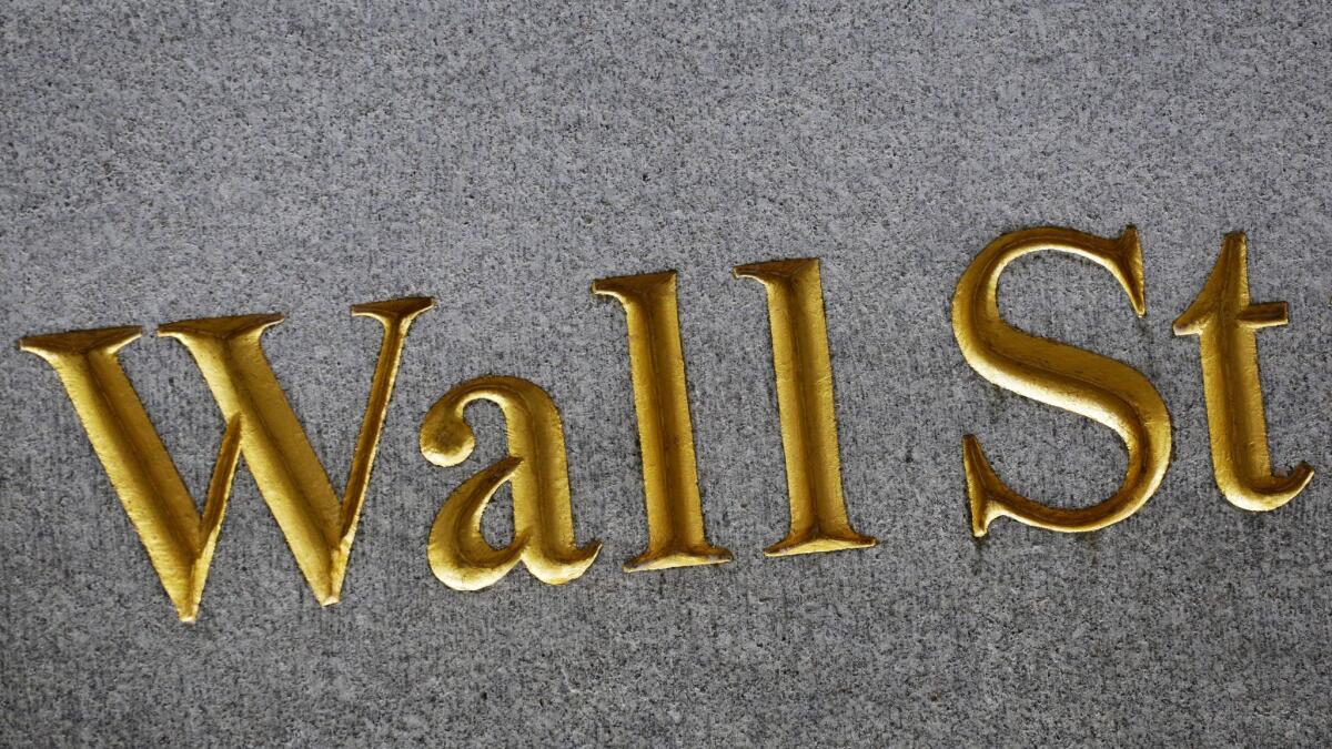 The street name is engraved on a building on Wall Street in New York.