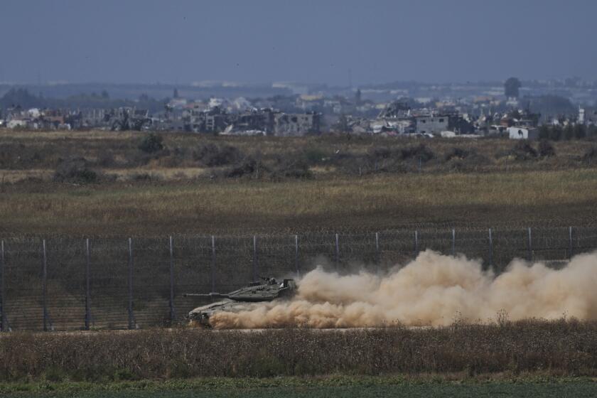 An Israeli tank moves near the Israeli-Gaza border, as seen from southern Israel, Sunday, May 12, 2024. (AP Photo/Tsafrir Abayov)