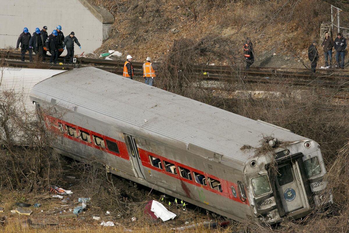 Emergency rescue personnel remove the body of a victim from the site of a train derailment in the Bronx borough of New York.