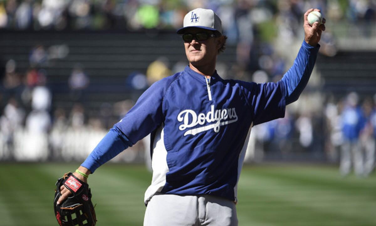 Dodgers Manager Don Mattingly throws during batting practice before Sunday's game against the San Diego Padres. Mattingly says he is confident in the technology behind Major League Baseball's new replay system.