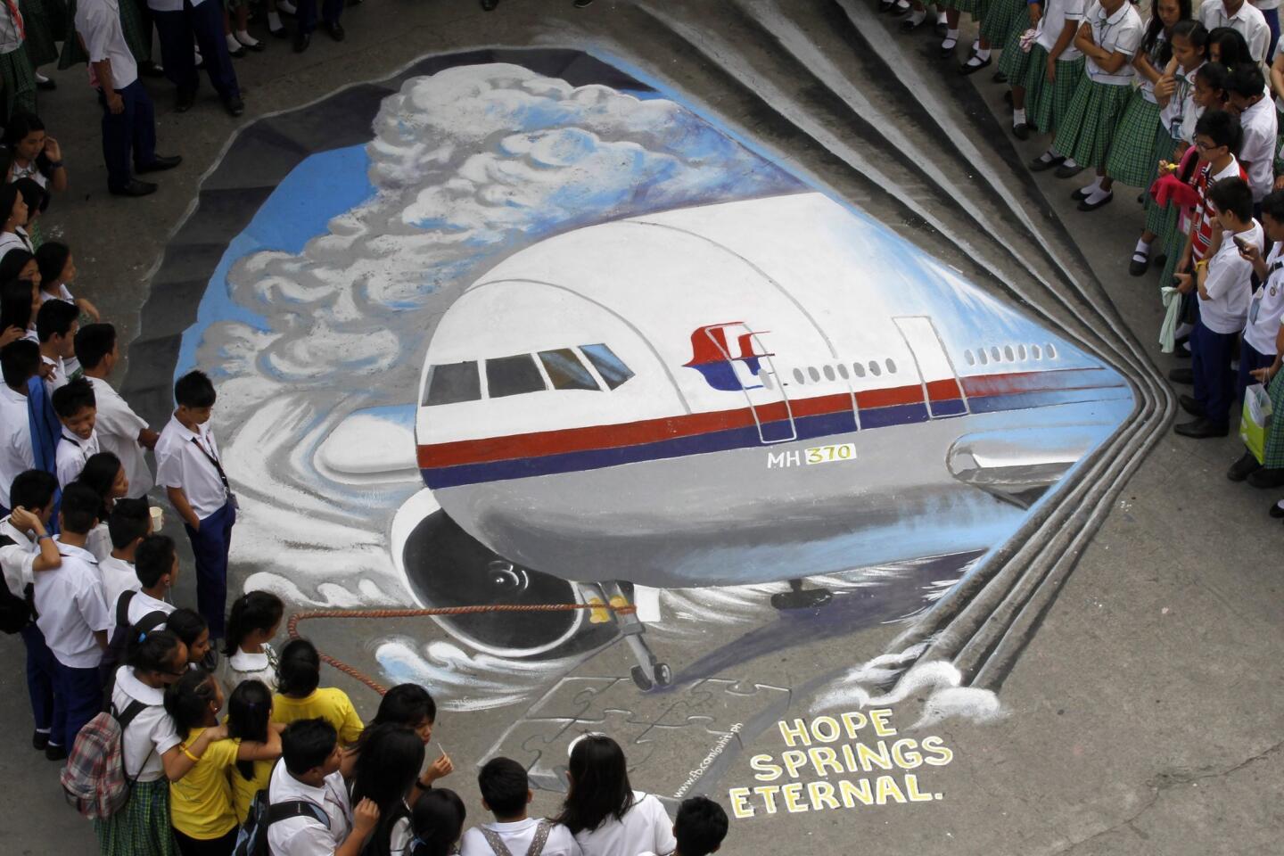 Filipino artists from the Guhit Visual Arts Group painted an image of Malaysia Airlines Flight MH370 at the Benigno Ninoy Aquino High School grounds in Makati City, south of Manila, Philippines, 17 March 2014 to express hope and solidarity for the passengers and crew of the missing Malaysia Airlines flight 370.