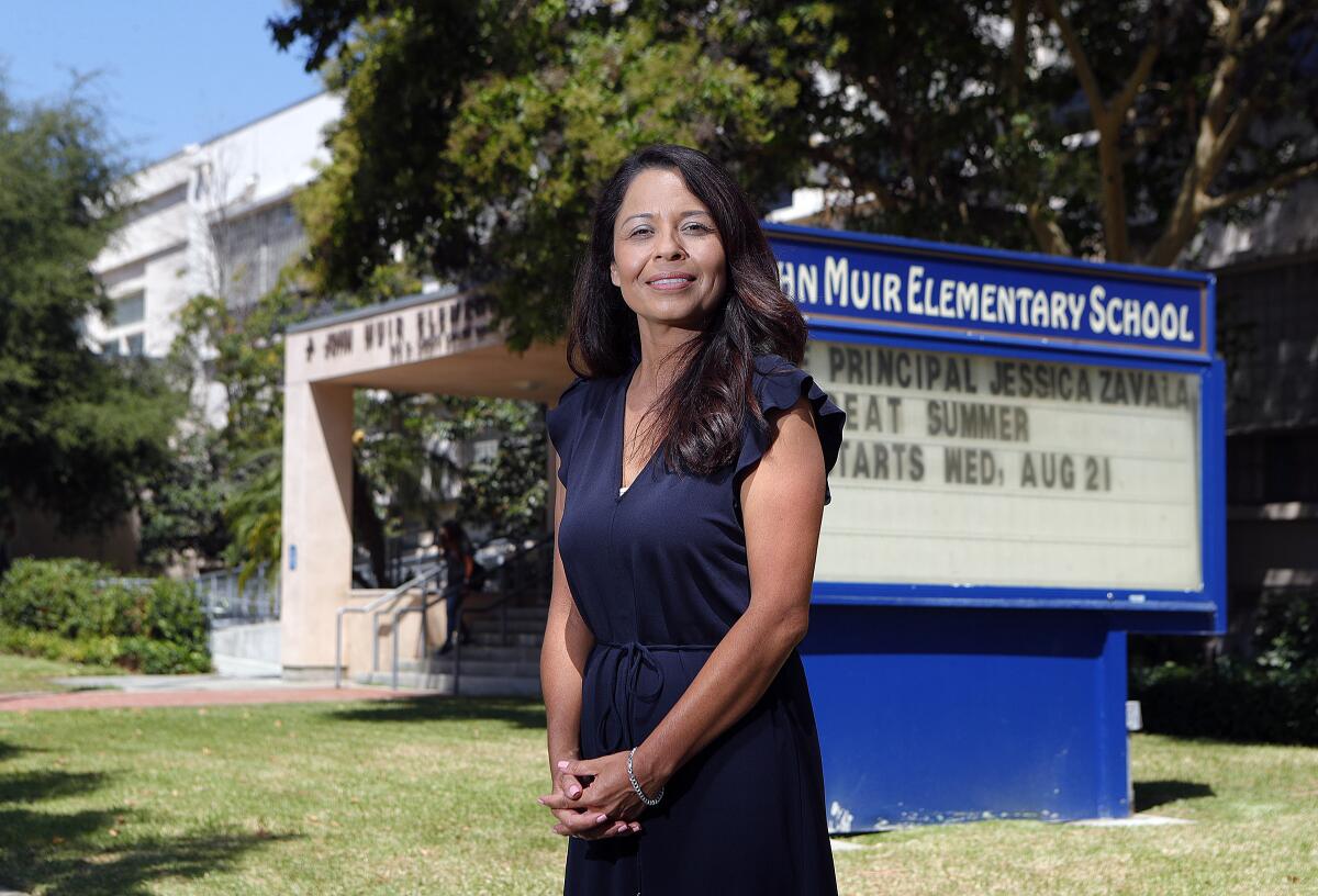 Jessica Zavala, Muir Elementary School's new principal, stands in front of the marquee introducing her to the campus. Zavala, who started her teaching career in Glendale Unified, where she also was an elementary and secondary student and graduated from Glendale High. She previously was a vice principal in South Pasadena.