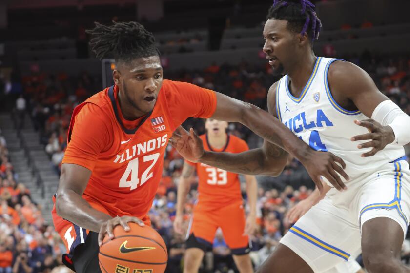 Illinois forward Dain Dainja (42) drives against UCLA forward Kenneth Nwuba (14) during the first half.