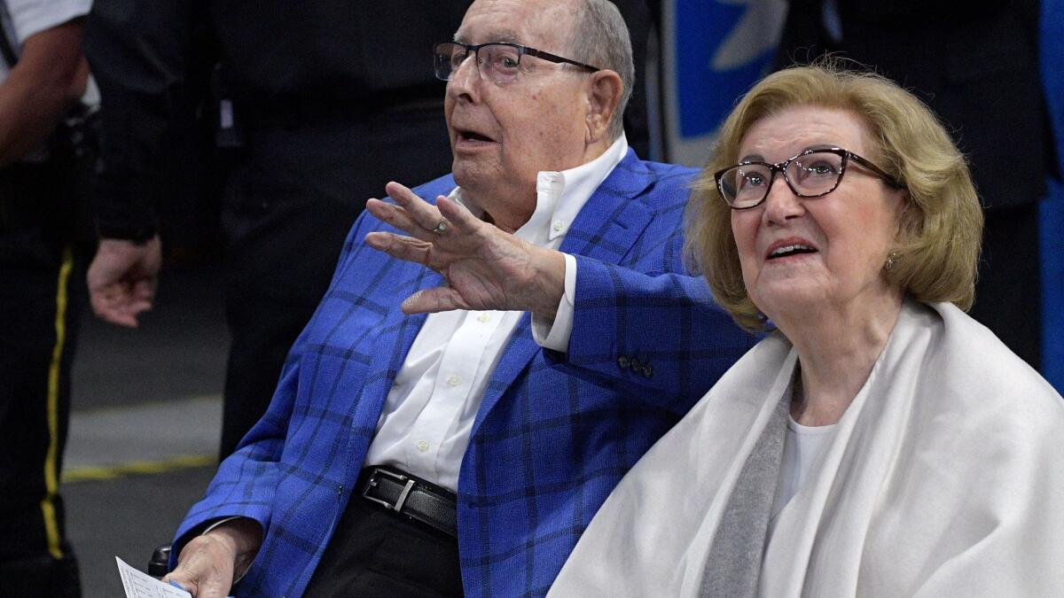 Helen DeVos and her husband Rich sitting courtside at an Orlando Magic game in March.