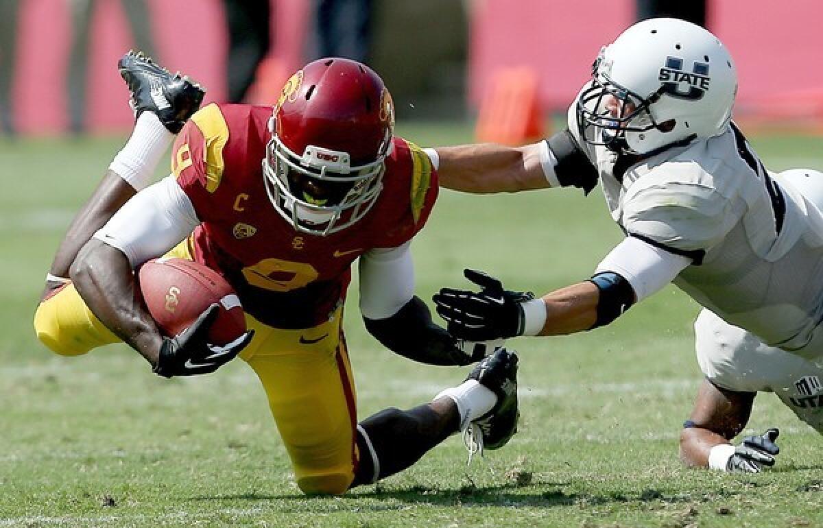 USC receiver Marqise Lee makes a catch against Utah State safety Cameron Sanders.