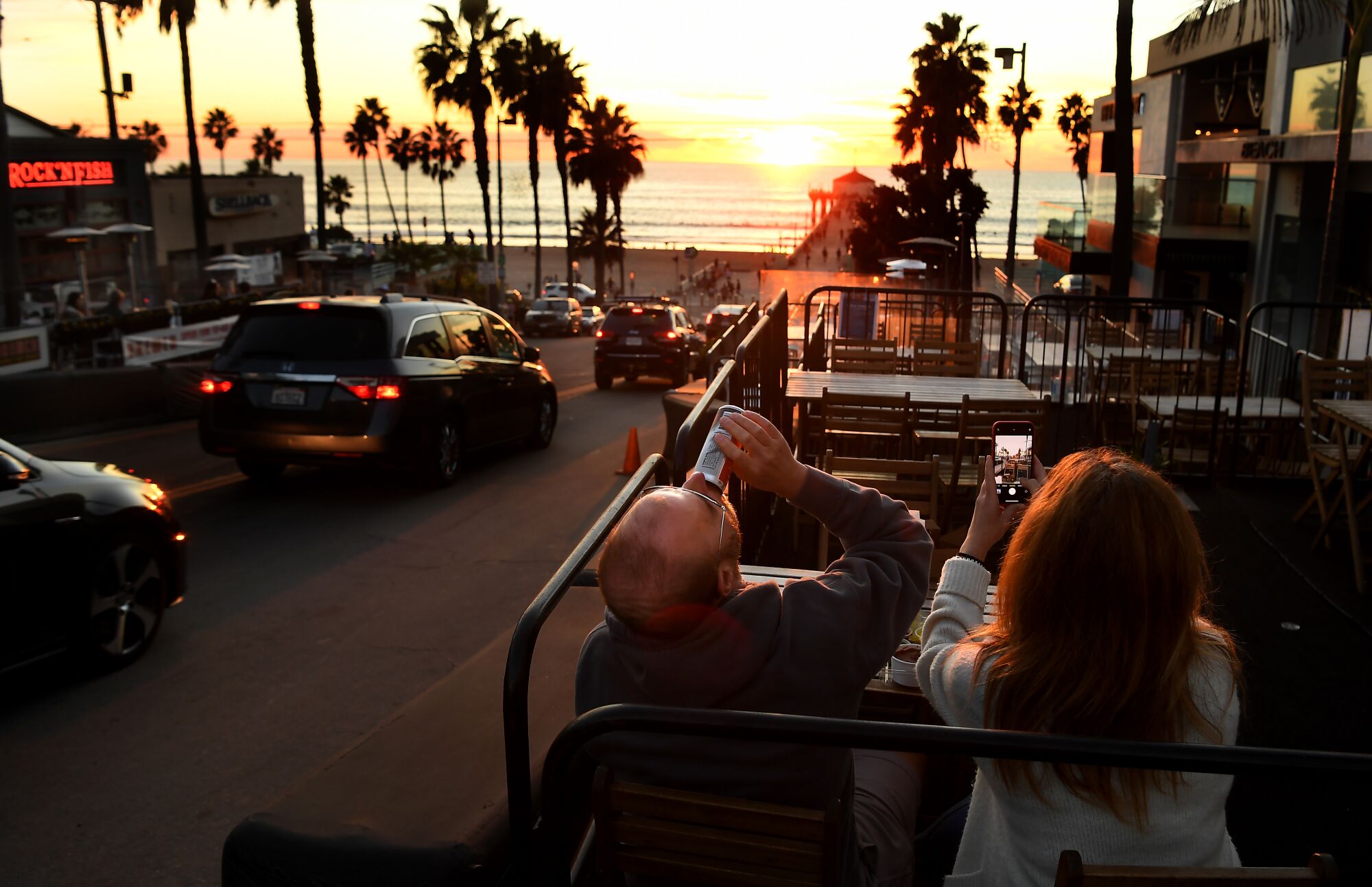 Bryan Yudko and his wife, Pam, enjoy a meal and the view in Manhattan Beach recently as a new shutdown loomed in L.A. County.